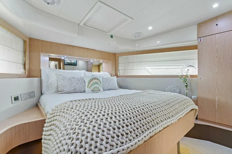Big Deck Energy Yacht Photos Pics Luxurious bedroom interior of 2013 Ferretti Yachts 620 with cozy bedding and modern design.