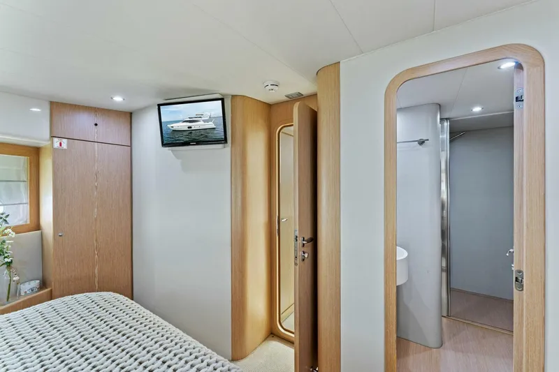 Big Deck Energy Yacht Photos Pics Luxurious bedroom interior of 2013 Ferretti Yachts 620 with ensuite bathroom.