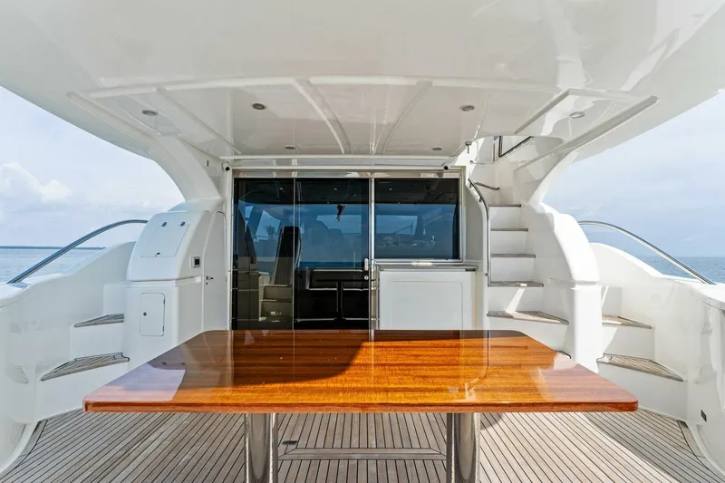 Big Deck Energy Yacht Photos Pics Luxurious 2013 Ferretti Yachts 620 deck with sleek wooden table and modern design.