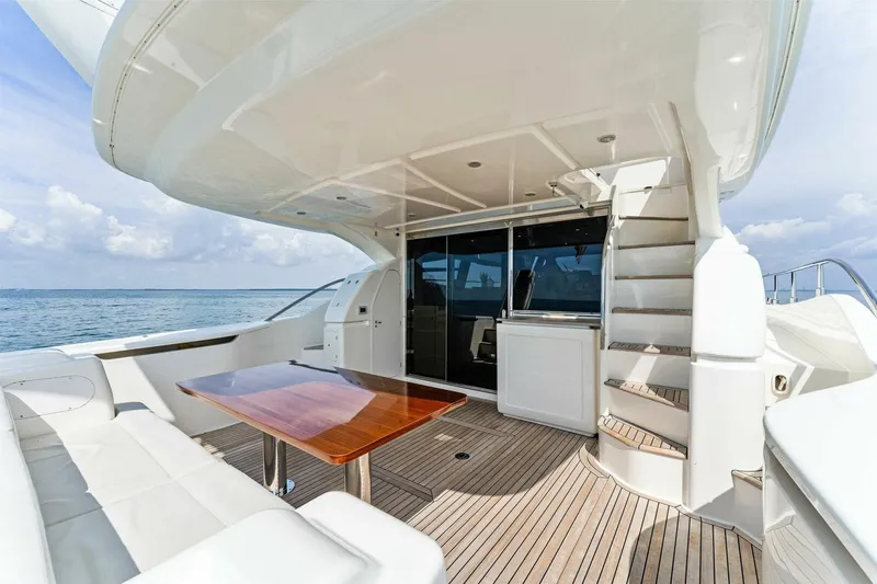 Big Deck Energy Yacht Photos Pics Luxurious 2013 Ferretti Yachts 620 deck with seating, table, and ocean view.