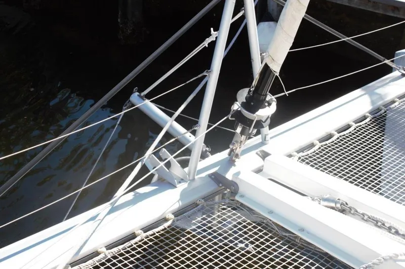 Jungle Goddess Yacht Photos Pics 2022 Lagoon 46 catamaran rigging and netting detail by the water.