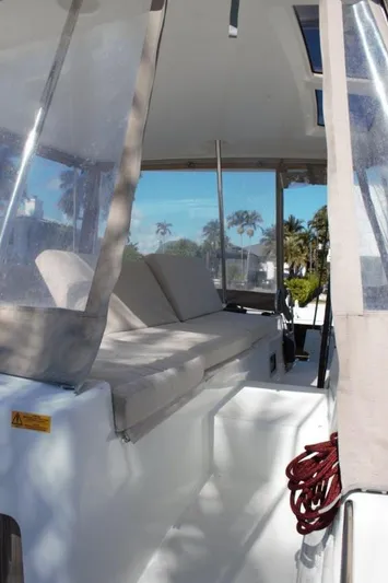 Jungle Goddess Yacht Photos Pics 2022 Lagoon 46 yacht interior with cushioned seating and clear canopy.