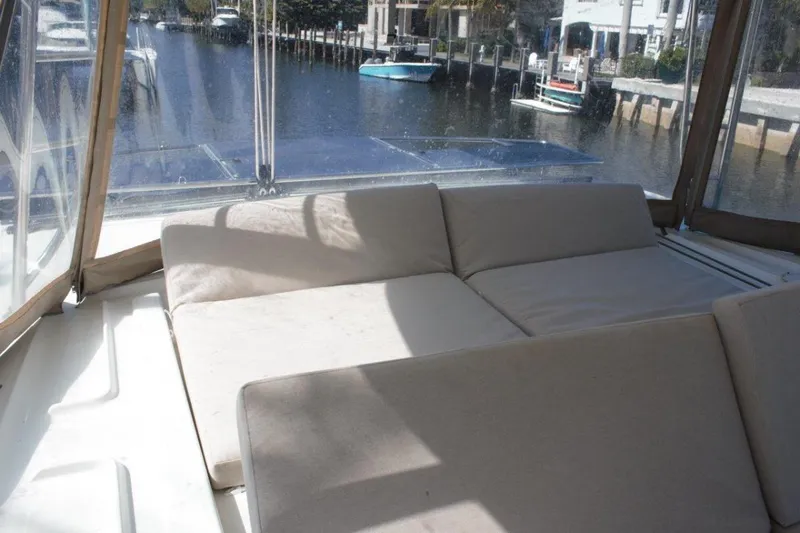 Jungle Goddess Yacht Photos Pics 2022 Lagoon 46 yacht interior with beige seating, overlooking a serene waterfront.