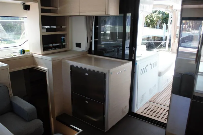 Jungle Goddess Yacht Photos Pics Interior of 2022 Lagoon 46 yacht, featuring modern kitchen and spacious seating area.