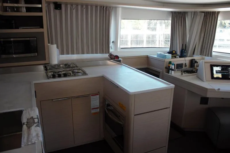 Jungle Goddess Yacht Photos Pics Modern kitchen interior of 2022 Lagoon 46 yacht with sleek design and ample natural light.