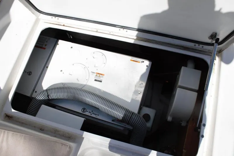 Jungle Goddess Yacht Photos Pics Engine compartment of a 2022 Lagoon 46 catamaran, featuring mechanical components and hoses.