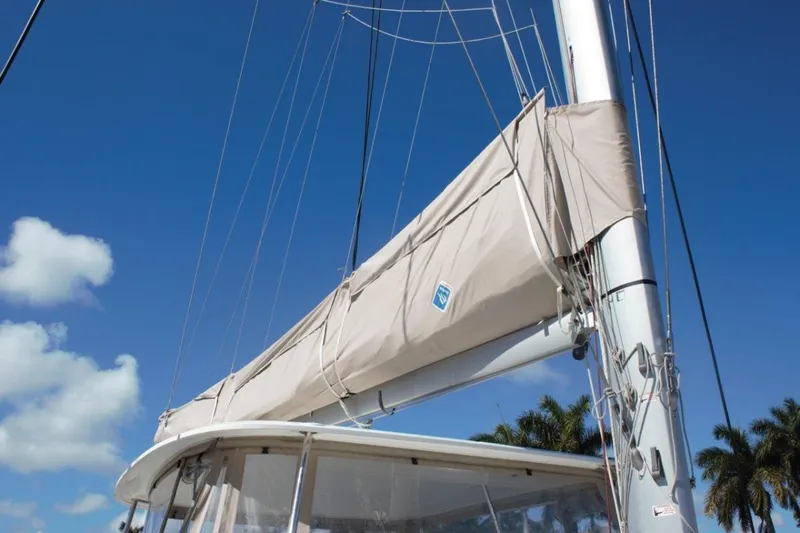 Jungle Goddess Yacht Photos Pics Lagoon 46 sailboat mast and sail cover against a clear blue sky, 2022 model.