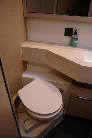 Jungle Goddess Yacht Photos Pics 2022 Lagoon 46 yacht bathroom with modern toilet and sleek countertop design.