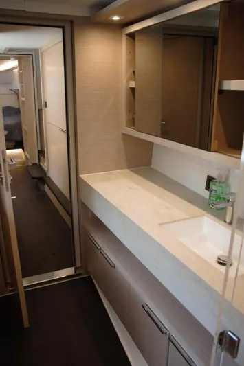 Jungle Goddess Yacht Photos Pics Modern bathroom interior of 2022 Lagoon 46 yacht, featuring sleek design and ample storage.