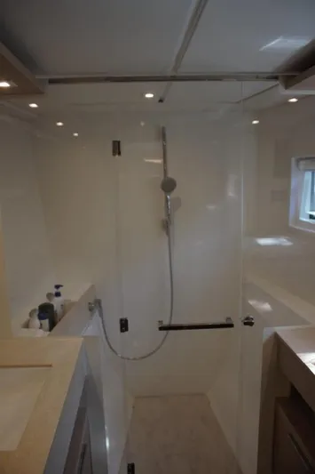 Jungle Goddess Yacht Photos Pics Modern bathroom in 2022 Lagoon 46 yacht with sleek shower and elegant fixtures.