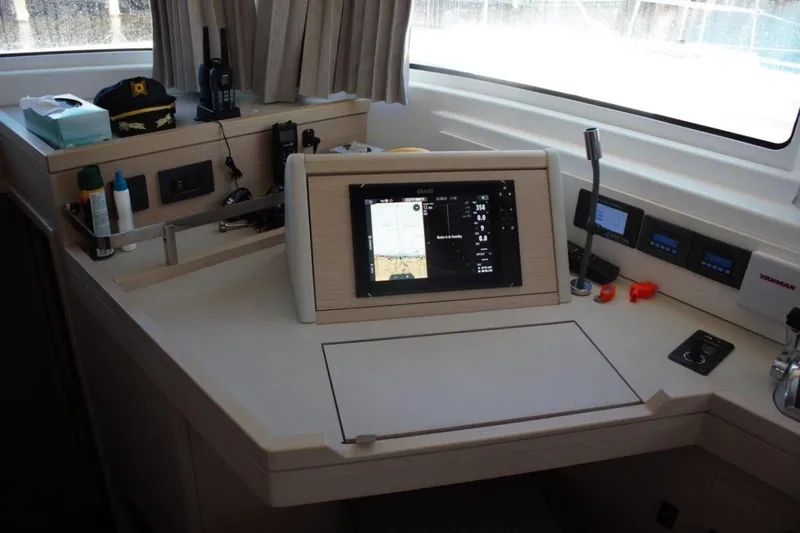 Jungle Goddess Yacht Photos Pics Navigation station of 2022 Lagoon 46 catamaran with modern equipment and controls.