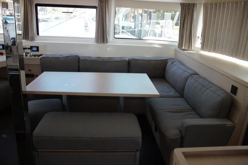 Jungle Goddess Yacht Photos Pics Interior of 2022 Lagoon 46 catamaran with cozy seating and dining table.