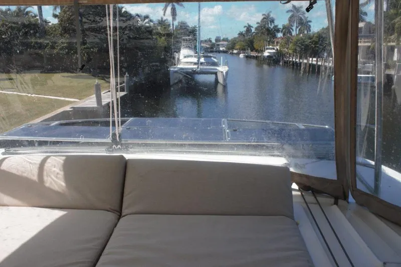 Jungle Goddess Yacht Photos Pics 2022 Lagoon 46 yacht interior with canal view, featuring comfortable seating and tropical surroundings.