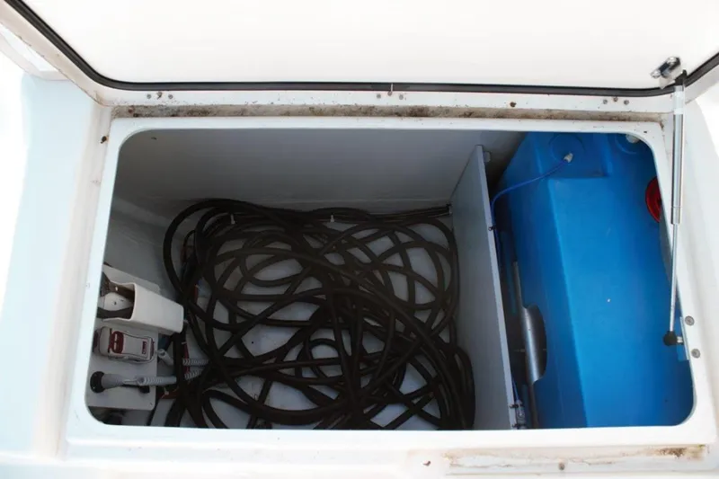 Jungle Goddess Yacht Photos Pics Open storage compartment on 2022 Lagoon 46 catamaran with coiled rope and blue tank.