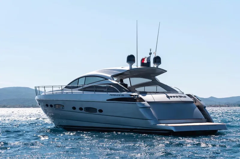  Yacht Photos Pics 2006 Pershing 56 yacht cruising on open water under clear skies.