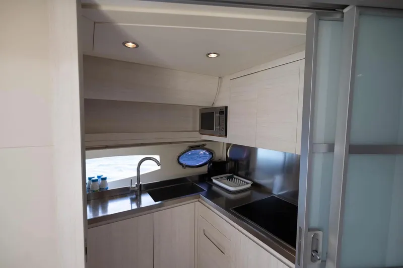  Yacht Photos Pics Modern kitchen interior of 2006 Pershing 56 yacht with sleek design and stainless steel appliances.