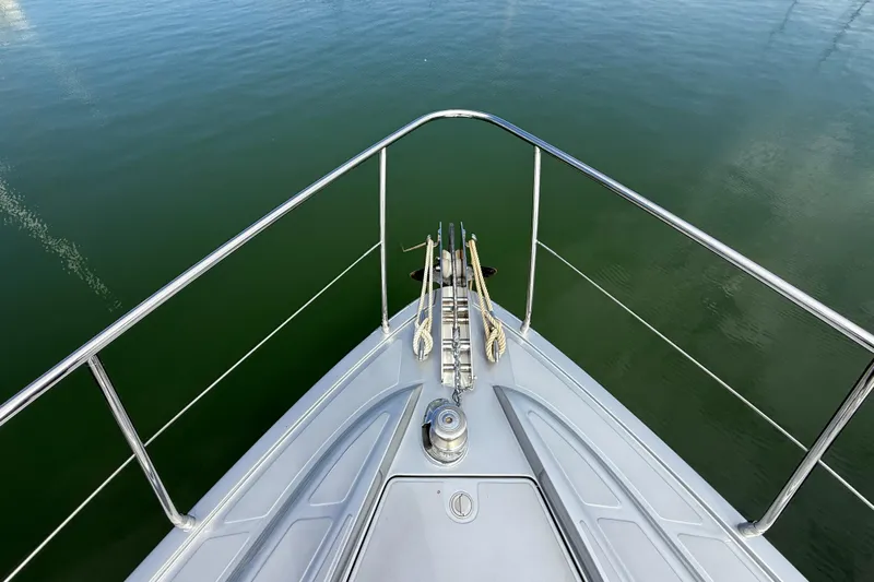  Yacht Photos Pics Bow view of 2006 Pershing 56 yacht on calm green water.