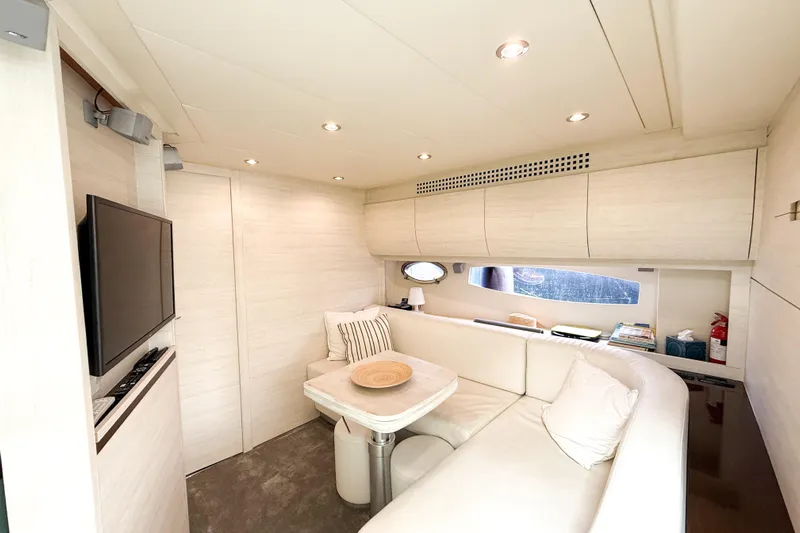  Yacht Photos Pics Luxurious interior of 2006 Pershing 56 yacht with cozy seating and modern amenities.