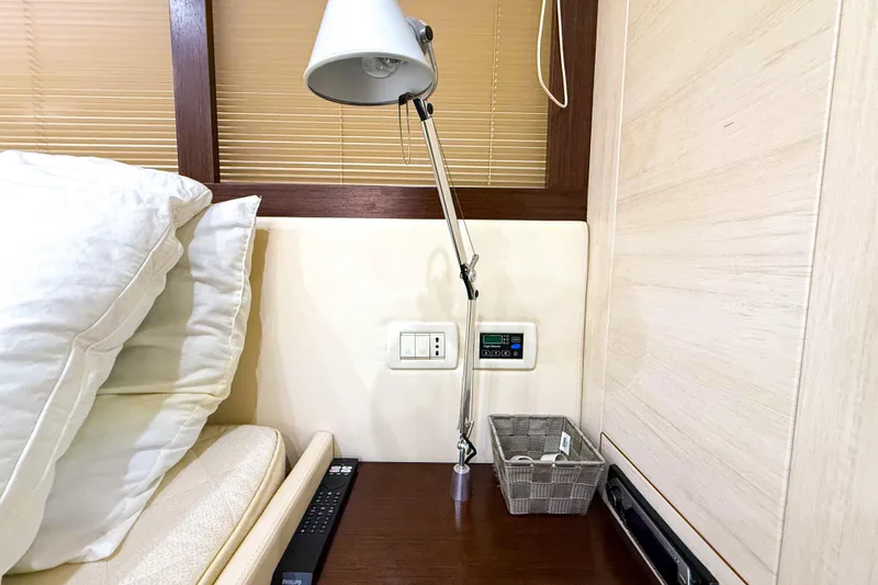  Yacht Photos Pics Interior of 2006 Pershing 56 yacht with lamp, pillows, and control panel.