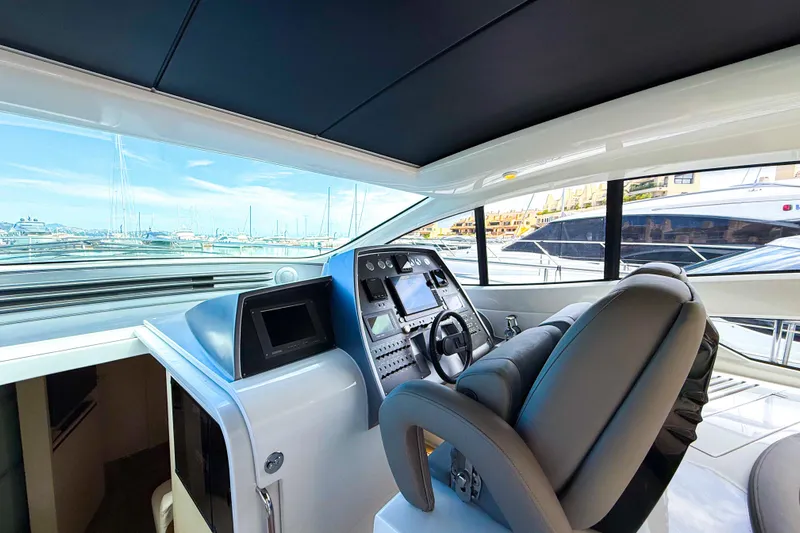  Yacht Photos Pics Luxurious 2006 Pershing 56 yacht cockpit with modern controls and marina view.