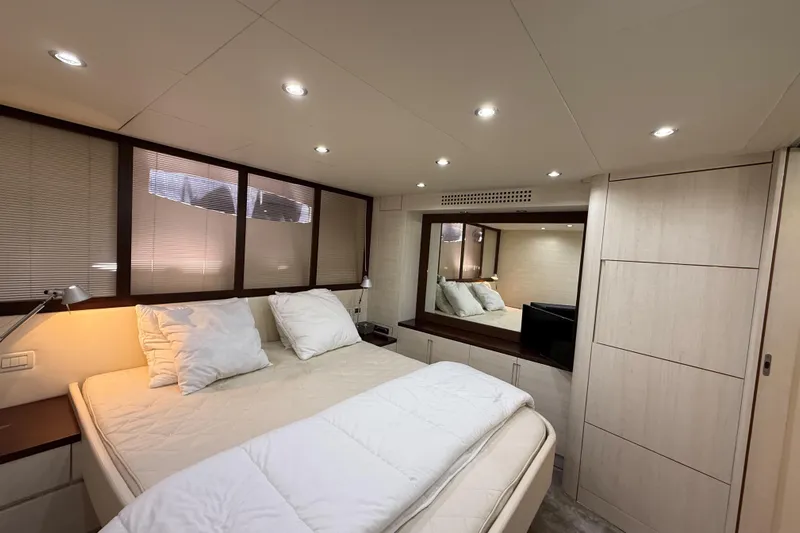  Yacht Photos Pics Luxurious bedroom interior of 2006 Pershing 56 yacht with modern design and ambient lighting.