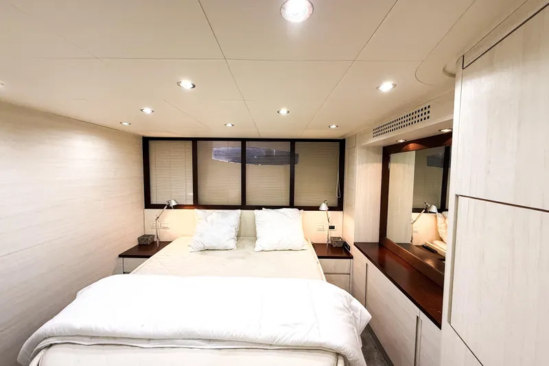  Yacht Photos Pics Luxurious bedroom interior of 2006 Pershing 56 yacht with modern lighting and elegant decor.