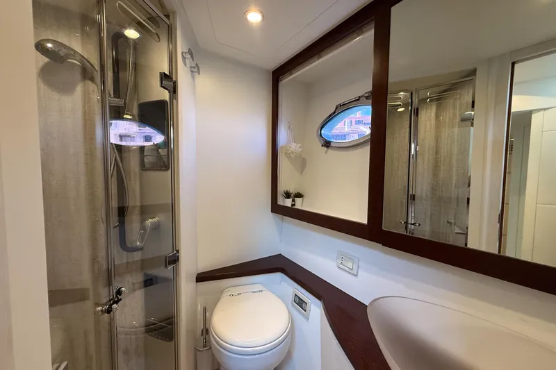  Yacht Photos Pics Luxurious bathroom in 2006 Pershing 56 yacht with shower, toilet, and mirror.