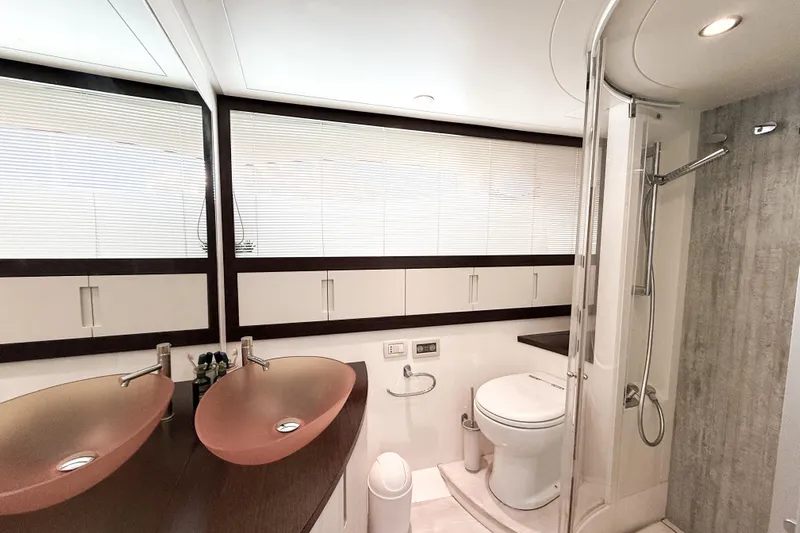  Yacht Photos Pics Luxurious bathroom in 2006 Pershing 56 yacht with dual sinks and modern shower.