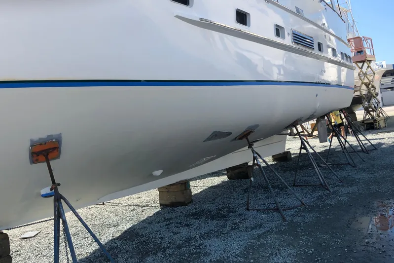 Noelani Yacht Photos Pics 1982 DeFever 52 Offshore Cruiser on stands for maintenance, side view.
