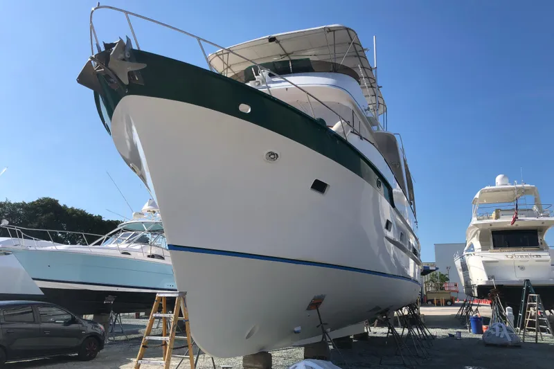 Noelani Yacht Photos Pics 1982 DeFever 52 Offshore Cruiser yacht on dry dock under clear blue sky.