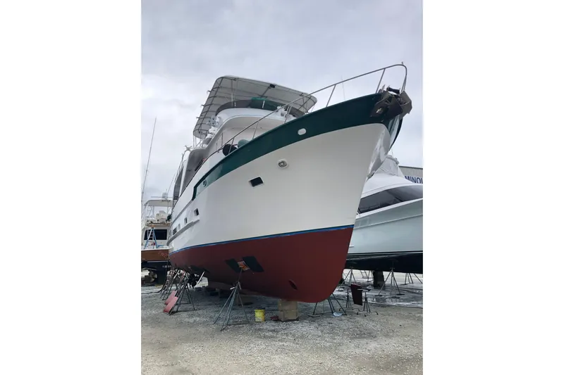 Noelani Yacht Photos Pics 1982 DeFever 52 Offshore Cruiser yacht on dry dock, showcasing its hull and structure.