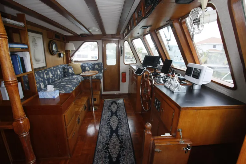 Noelani Yacht Photos Pics Interior of 1982 DeFever 52 Offshore Cruiser with wood paneling and navigation equipment.