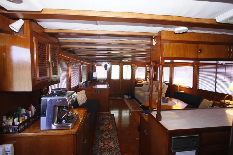 Noelani Yacht Photos Pics Interior of 1982 DeFever 52 Offshore Cruiser with wood paneling and cozy seating area.