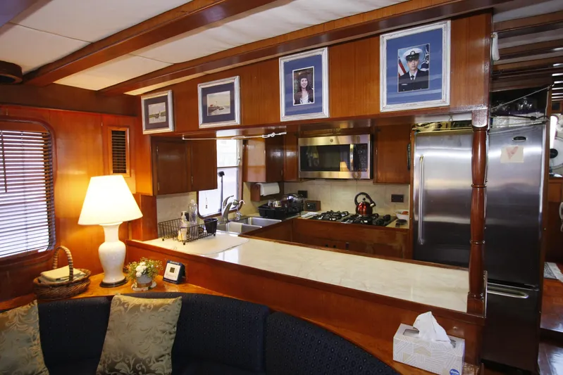 Noelani Yacht Photos Pics Interior of 1982 DeFever 52 Offshore Cruiser with cozy kitchen and seating area.