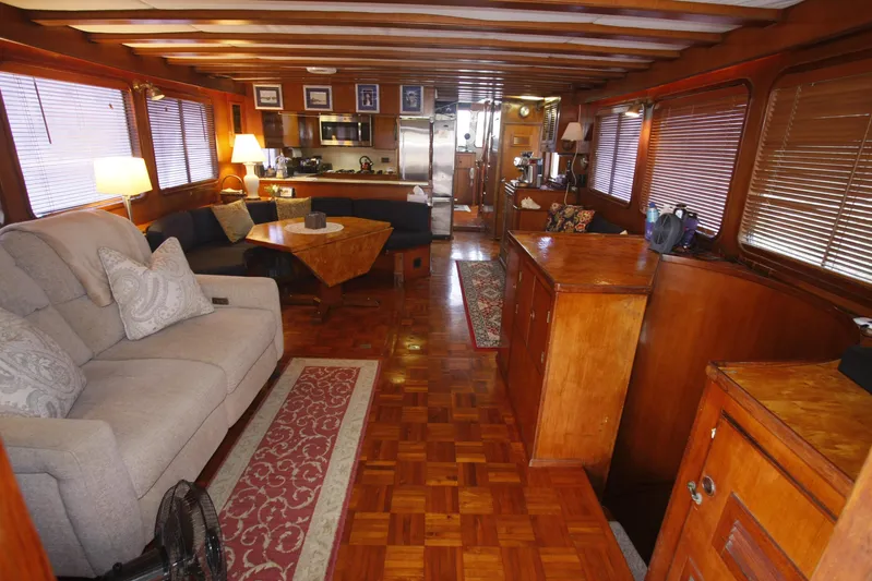 Noelani Yacht Photos Pics Luxurious interior of 1982 DeFever 52 Offshore Cruiser with wood finishes and cozy seating.