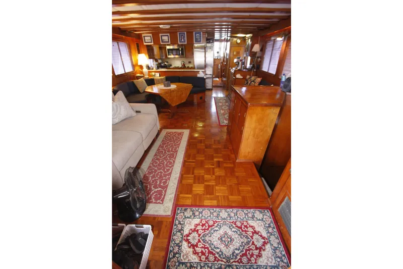 Noelani Yacht Photos Pics Interior of 1982 DeFever 52 Offshore Cruiser with wooden decor and cozy seating area.