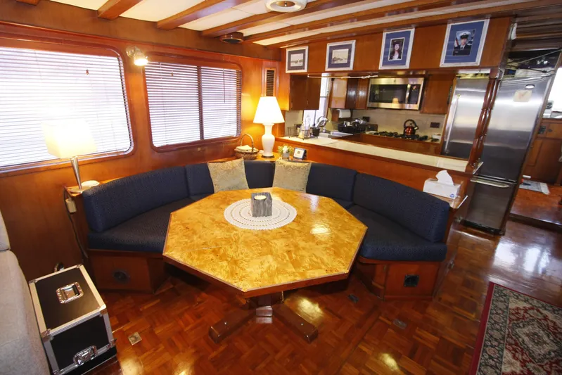 Noelani Yacht Photos Pics Interior of 1982 DeFever 52 Offshore Cruiser with cozy dining area and wooden decor.