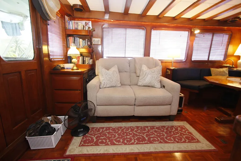 Noelani Yacht Photos Pics Interior of 1982 DeFever 52 Offshore Cruiser with cozy seating and wooden decor.