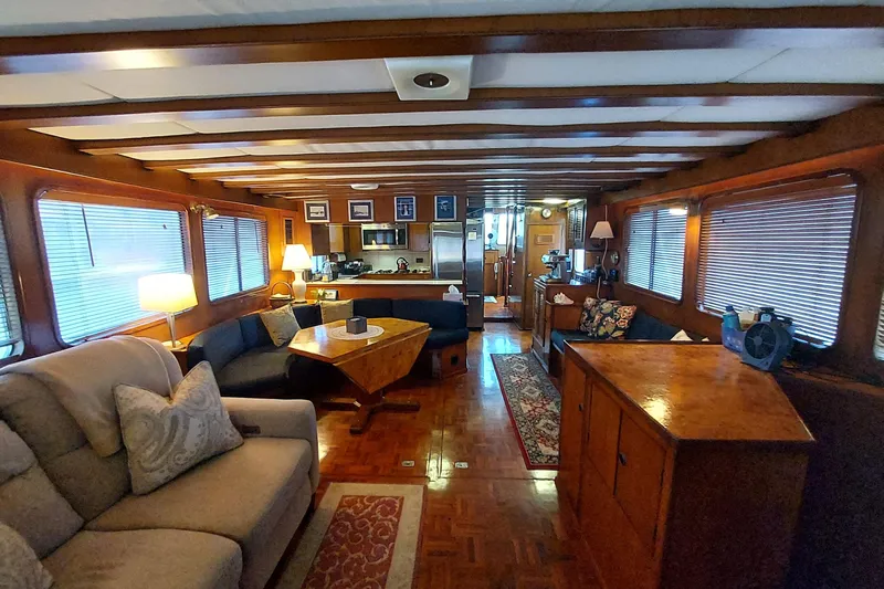 Noelani Yacht Photos Pics Interior of 1982 DeFever 52 Offshore Cruiser with cozy seating and wooden decor.
