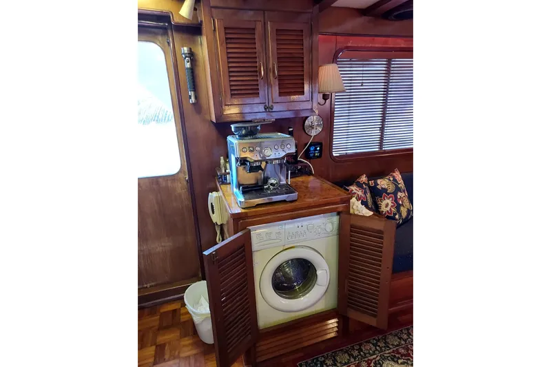 Noelani Yacht Photos Pics Interior of 1982 DeFever 52 Offshore Cruiser with coffee machine and washing machine.