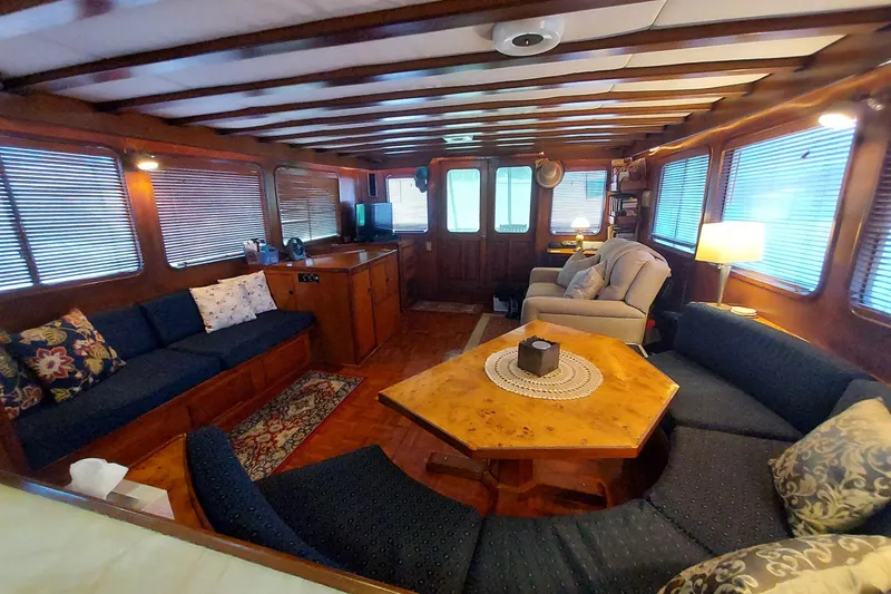 Noelani Yacht Photos Pics Luxurious interior of 1982 DeFever 52 Offshore Cruiser with cozy seating and elegant decor.