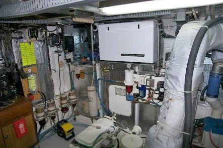 Noelani Yacht Photos Pics Engine room of 1982 DeFever 52 Offshore Cruiser with various mechanical components and equipment.