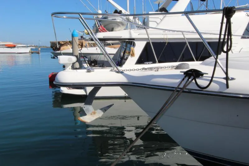  Yacht Photos Pics 2001 Tiara Yachts 3800 Open docked, showcasing sleek design and sturdy anchor.