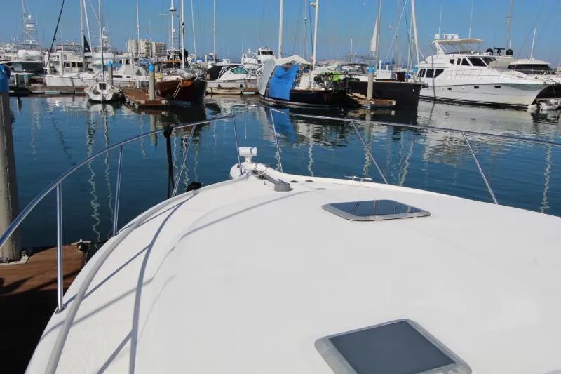  Yacht Photos Pics 2001 Tiara Yachts 3800 Open docked in a marina with other boats.