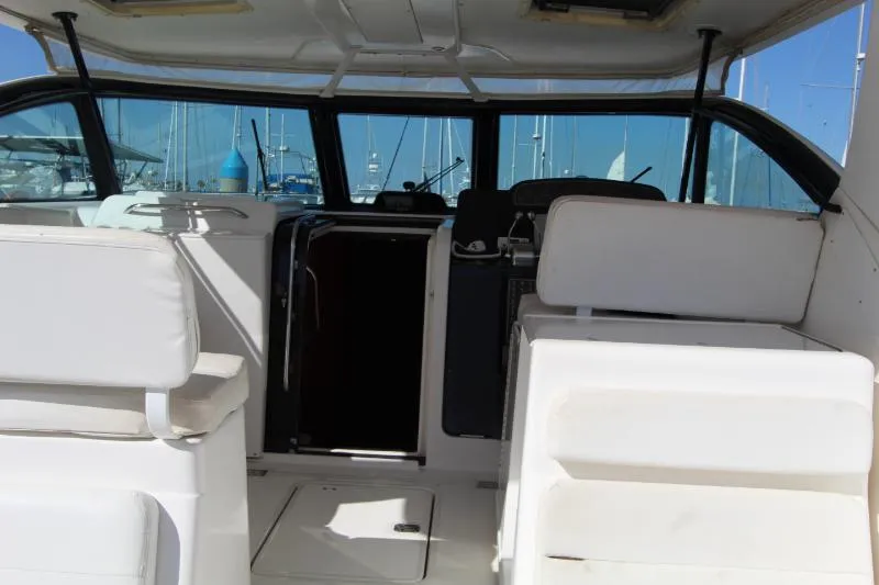  Yacht Photos Pics 2001 Tiara Yachts 3800 Open interior with white seating and marina view.