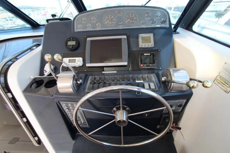  Yacht Photos Pics Helm of 2001 Tiara Yachts 3800 Open, featuring steering wheel and navigation controls.