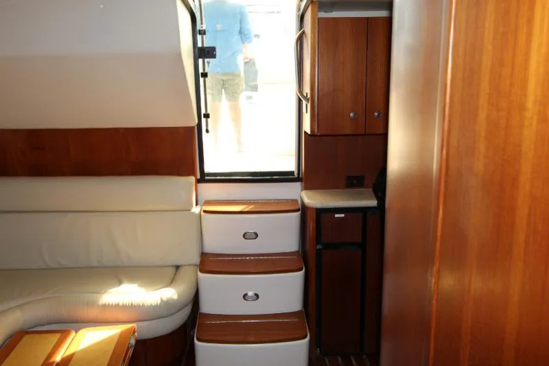  Yacht Photos Pics Interior of 2001 Tiara Yachts 3800 Open with wooden cabinetry and cushioned seating.