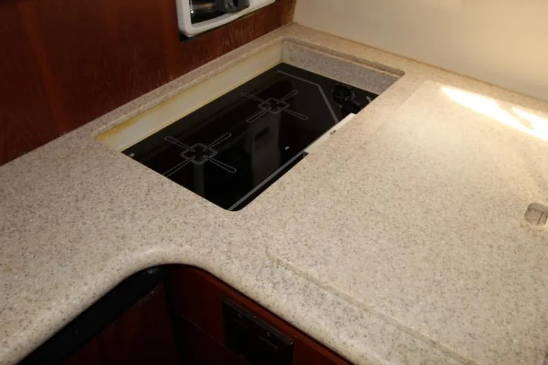  Yacht Photos Pics 2001 Tiara Yachts 3800 Open kitchen with sleek countertop and built-in stove.