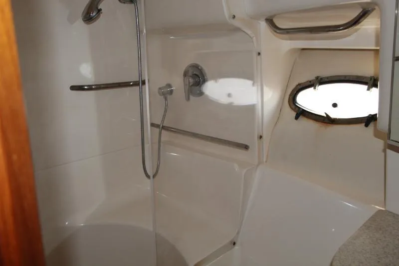  Yacht Photos Pics 2001 Tiara Yachts 3800 Open bathroom with shower and porthole window.