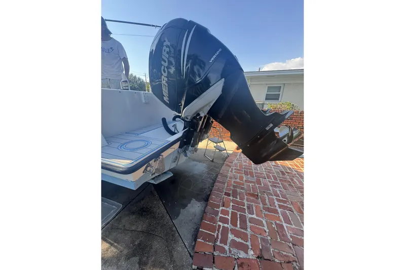  Yacht Photos Pics 2005 Contender 31 Open boat with Mercury Verado outboard engine, parked on brick driveway.